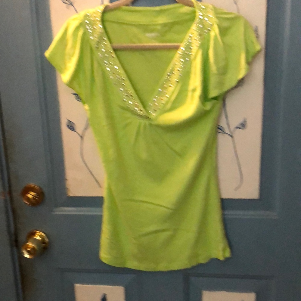 A light green top with embellished neckline